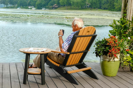 Man enjoying coffee sitting on Amish poly outdoor chair with side table
