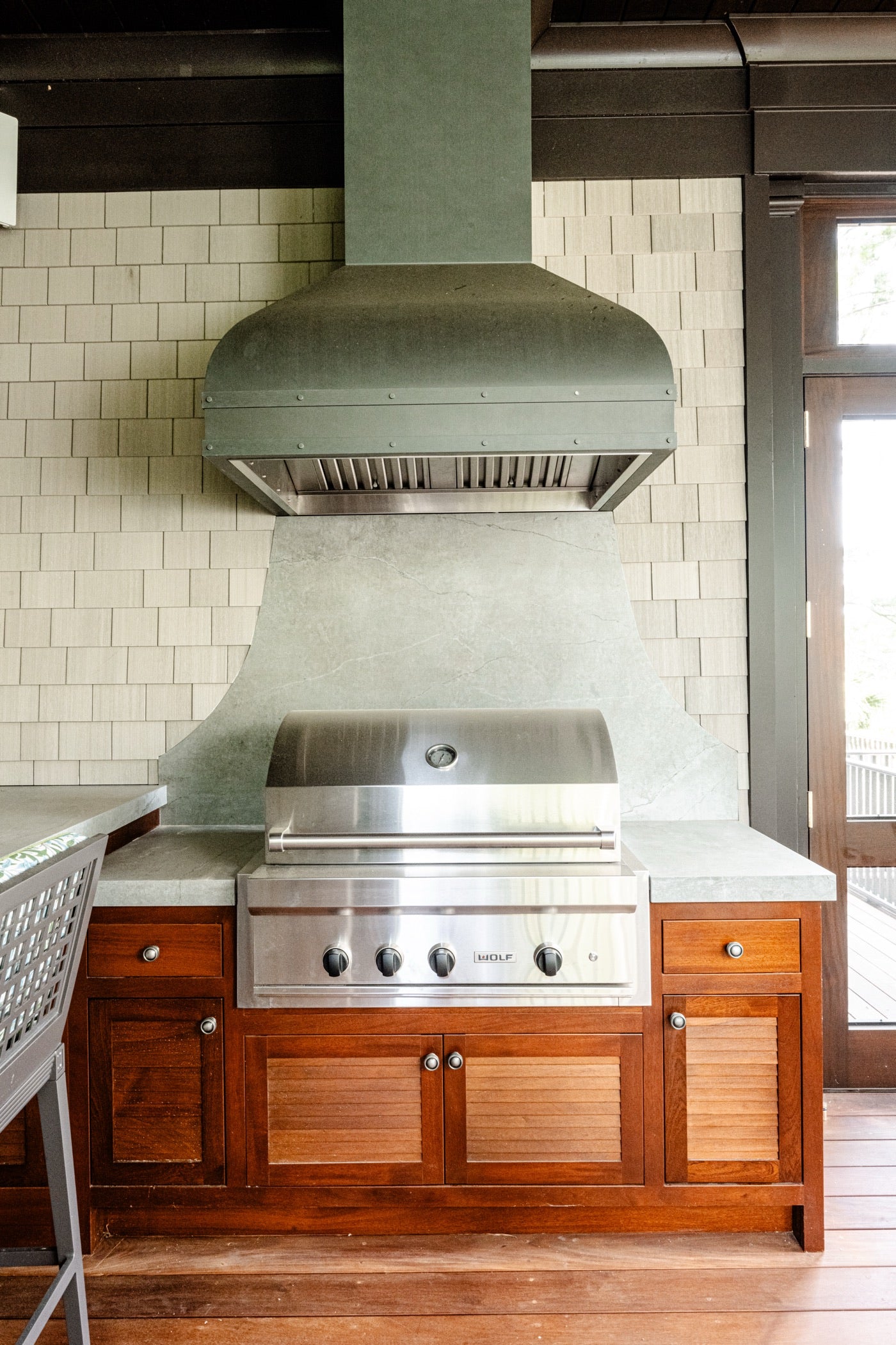 Outdoor kitchen custom Amish cabinetry with stainless grill and wood base cabinets