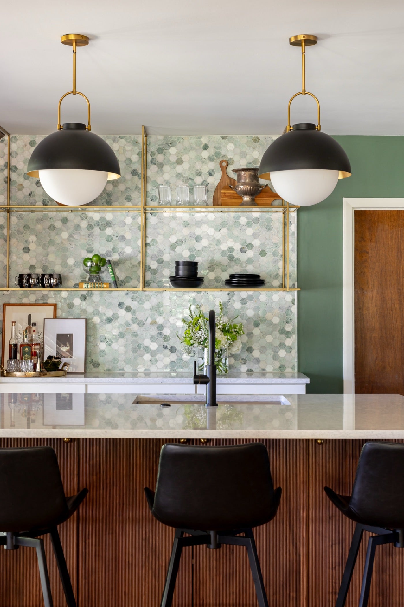 Custom wet bar cabinetry with glass storage and integrated lighting